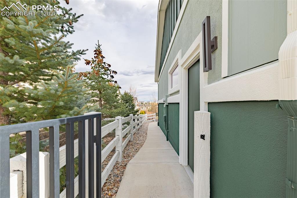 Sidewalk along the side leading to a metal gate