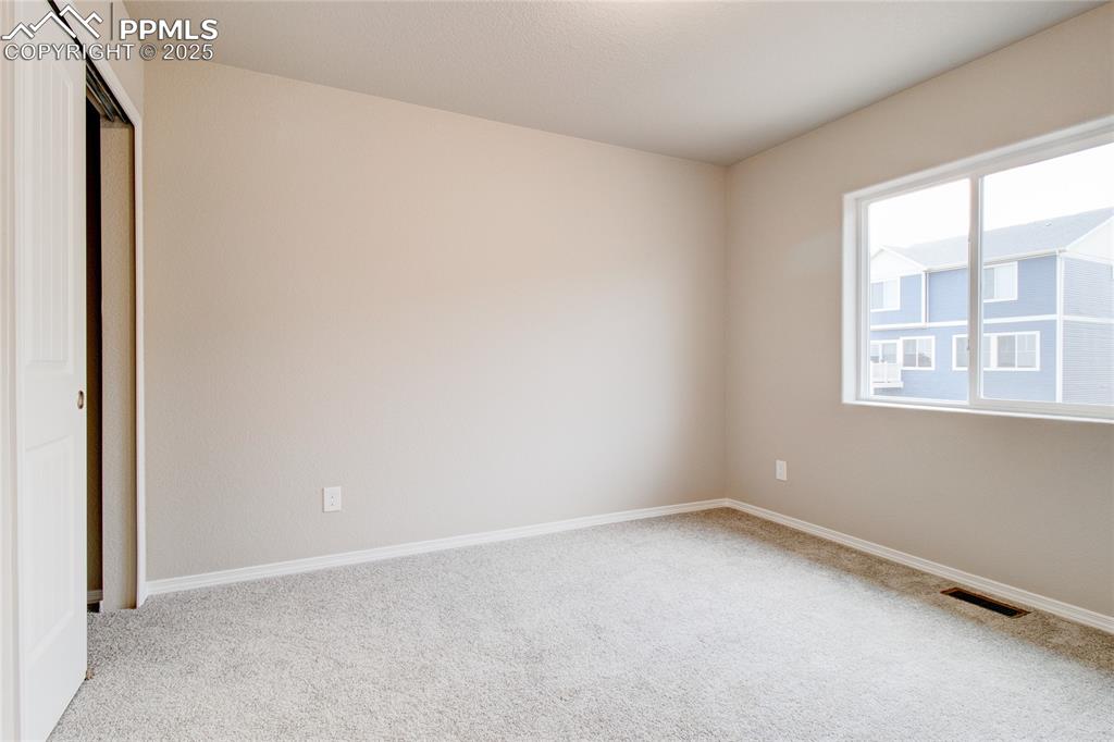 Unfurnished bedroom with a closet and carpet floors