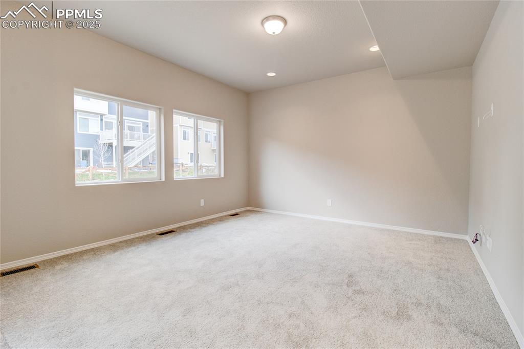 Spare room featuring carpet and recessed lighting