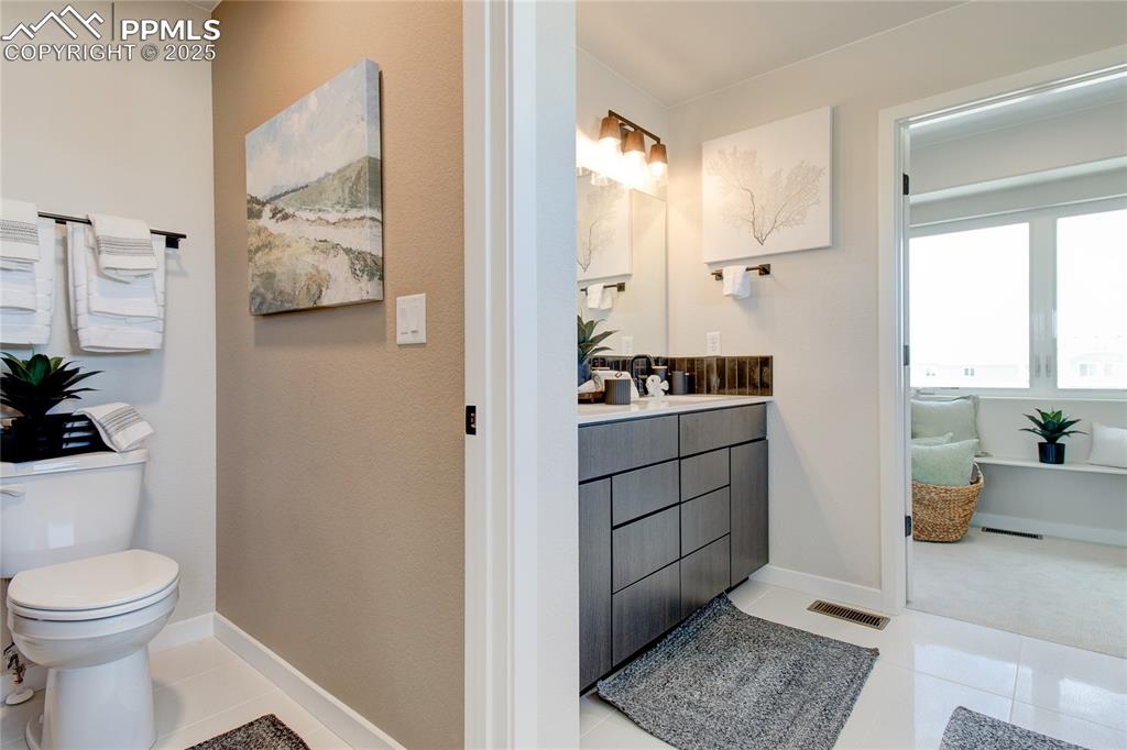 Bathroom featuring light tile patterned floors and vanity