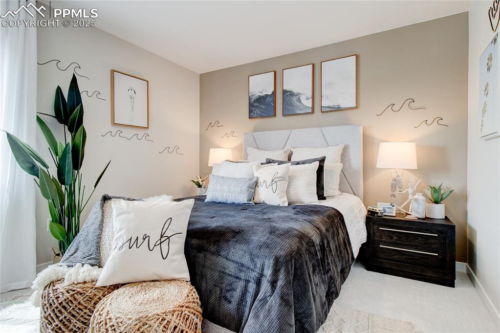 Bedroom featuring baseboards and carpet floors