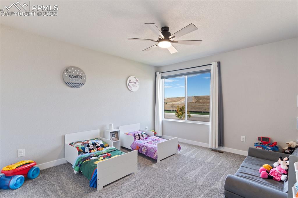 Playroom featuring carpet and a ceiling fan