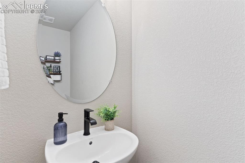 Bathroom with a textured wall and a sink