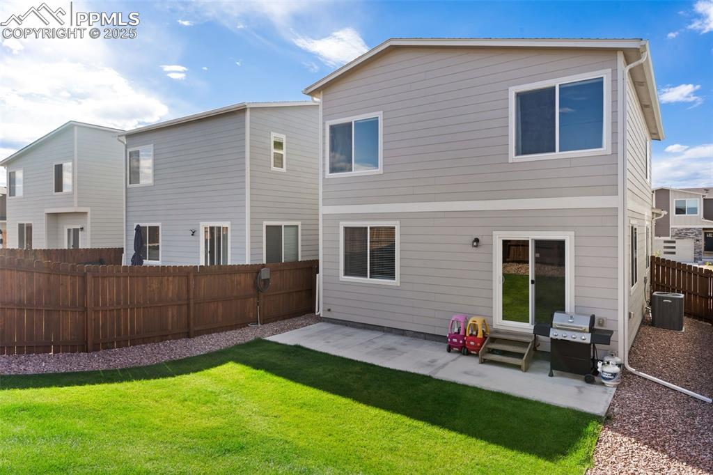 Back of property featuring a patio, a fenced backyard, and a residential view