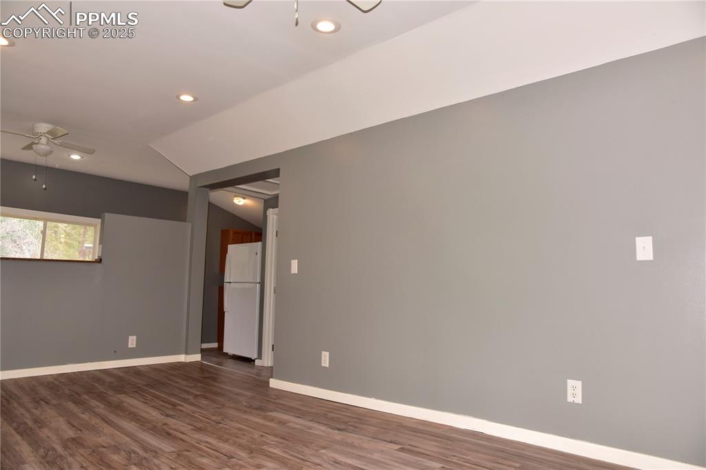 Empty room with ceiling fan, recessed lighting, dark wood-type flooring, and baseboards