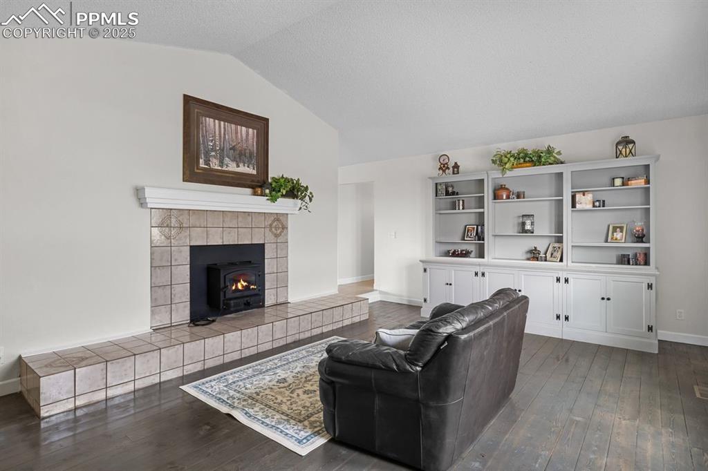 Living area featuring lofted ceiling and wood flooring