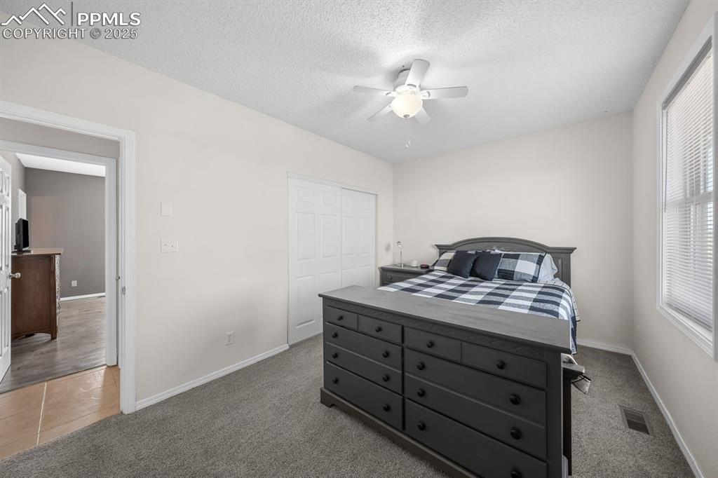 Bedroom featuring carpet and a ceiling fan