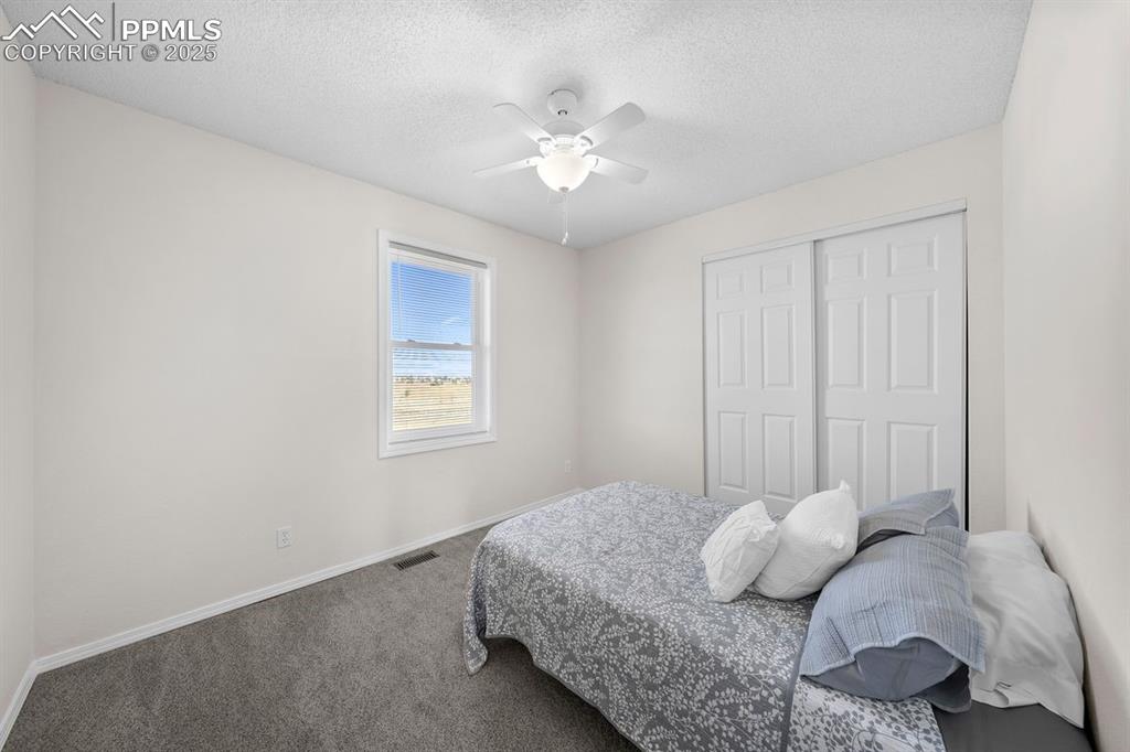 Bedroom featuring carpet and a ceiling fan