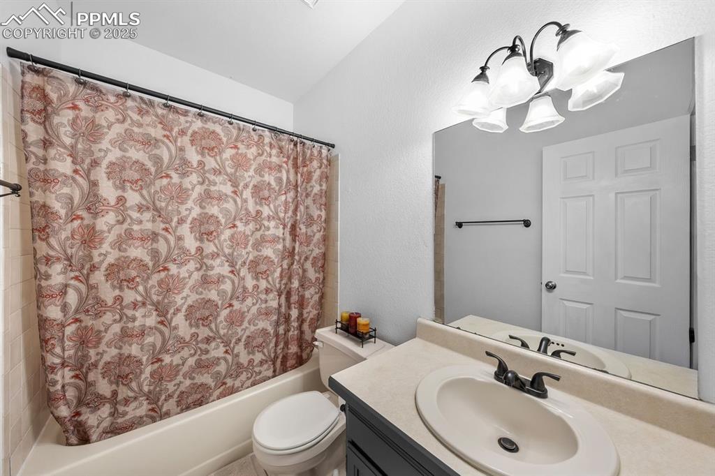 Full bath with shower / bath combo, vanity and chandelier