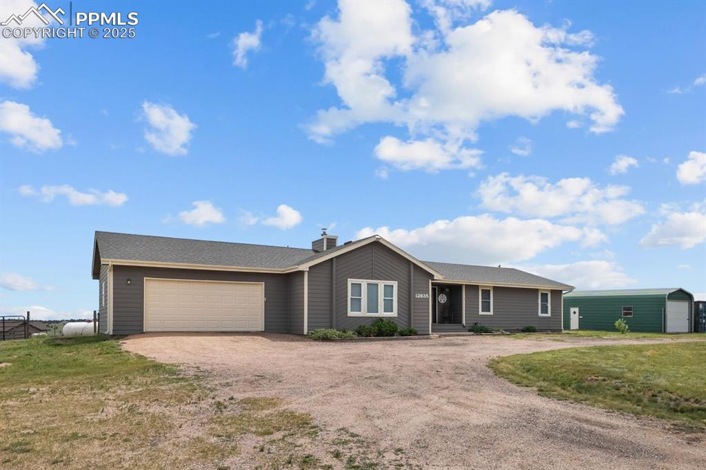 Ranch-style home featuring dirt circular driveway
