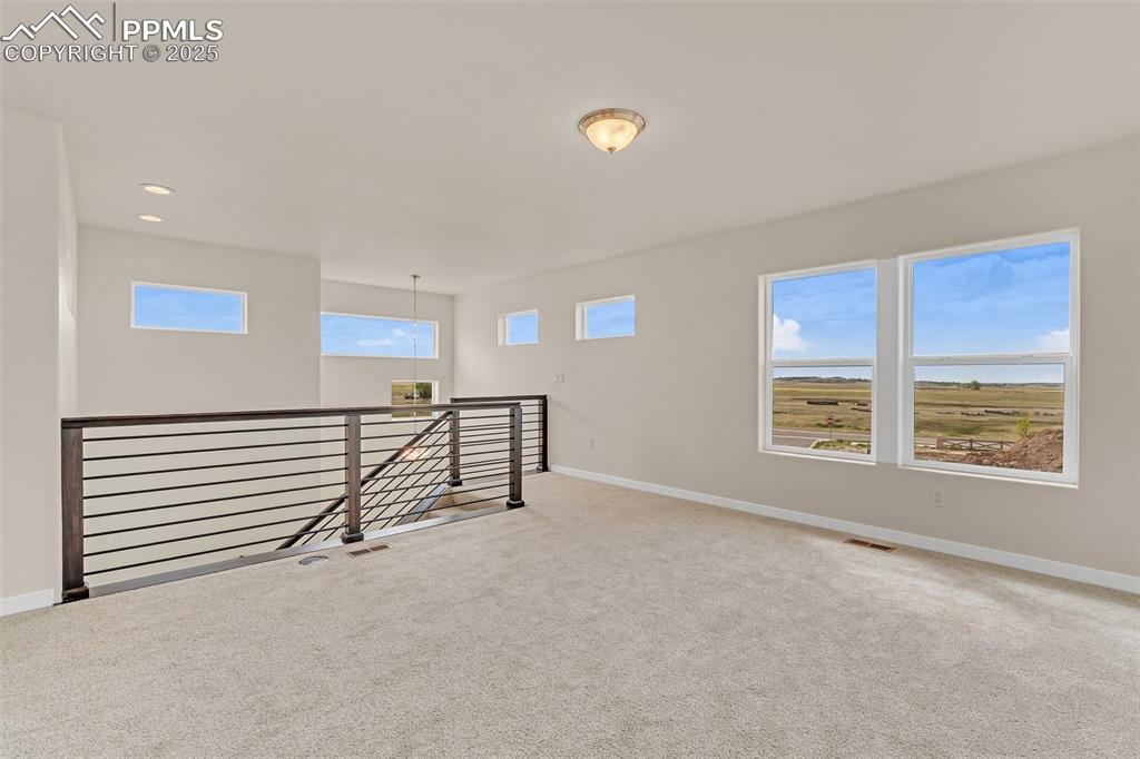 Unfurnished room featuring baseboards and carpet