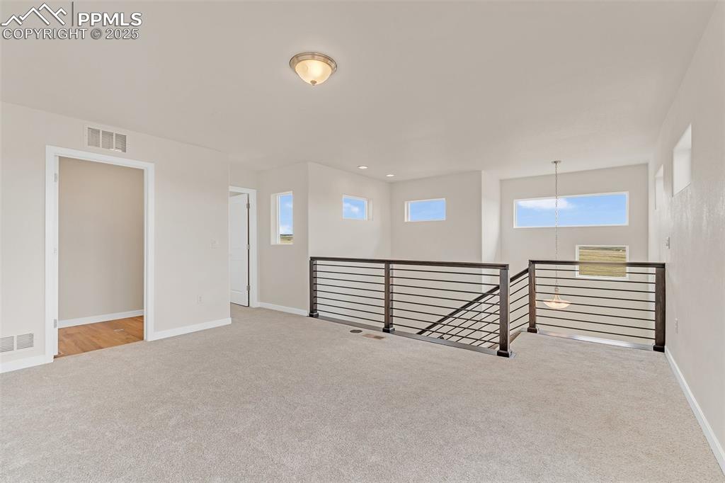 Empty room featuring light carpet