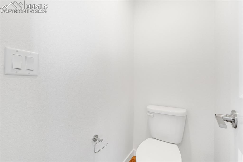 Bathroom with toilet and baseboards