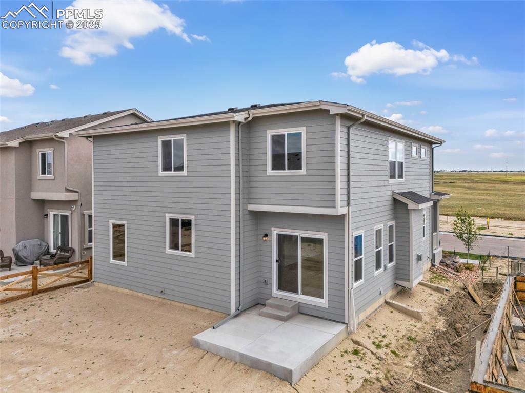 Rear view of property with a patio and entry steps