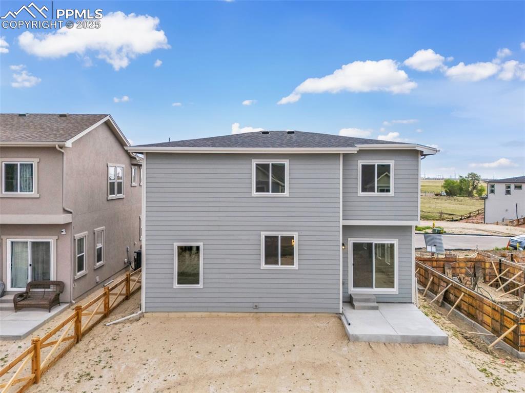 Rear view of property with a patio area and a fenced backyard
