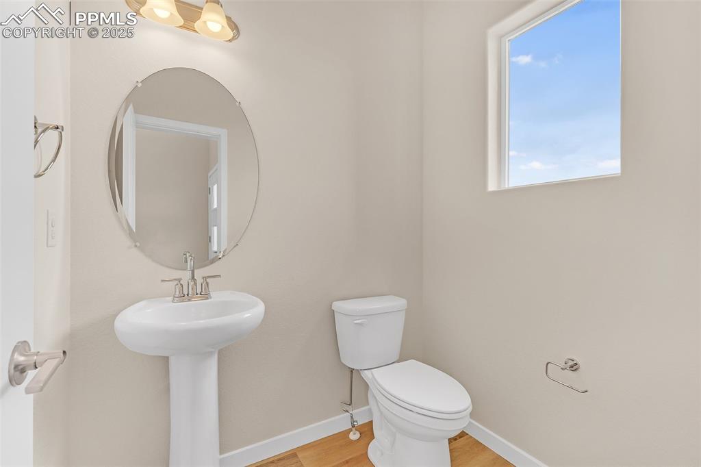Bathroom with baseboards and light wood-style flooring