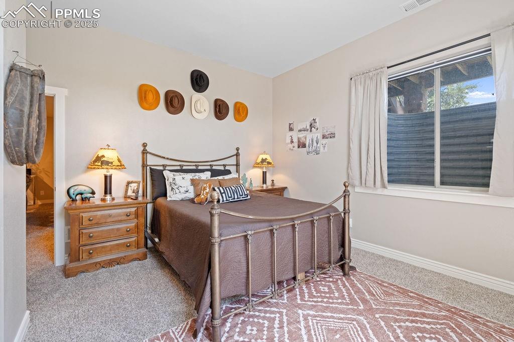 Bedroom with carpet flooring and baseboards