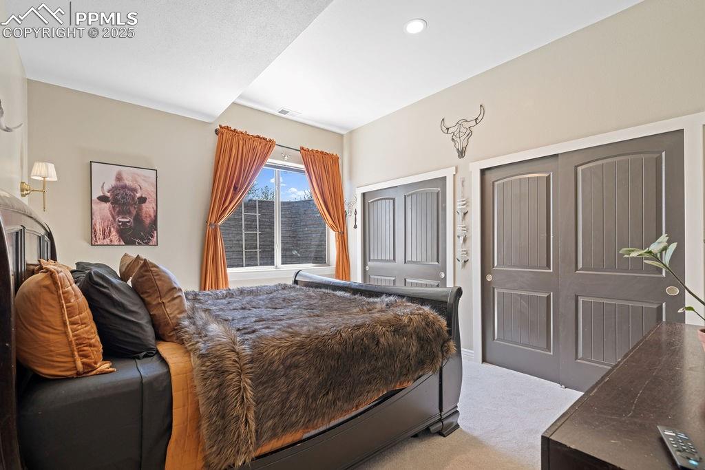Bedroom featuring light carpet and recessed lighting