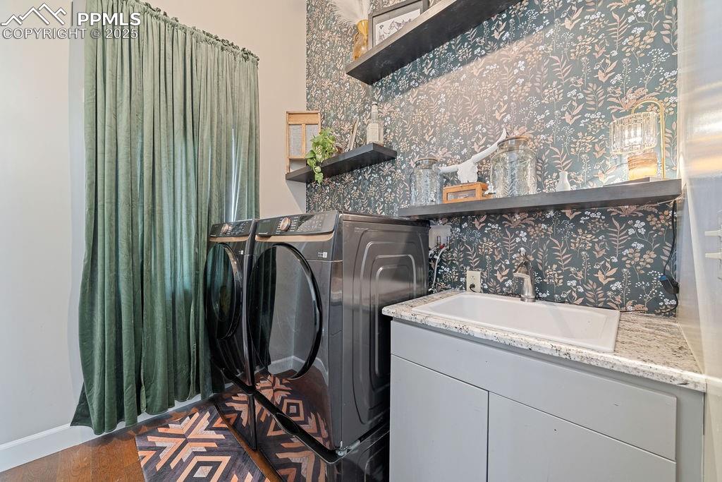Laundry area featuring separate washer and dryer and dark wood-type flooring