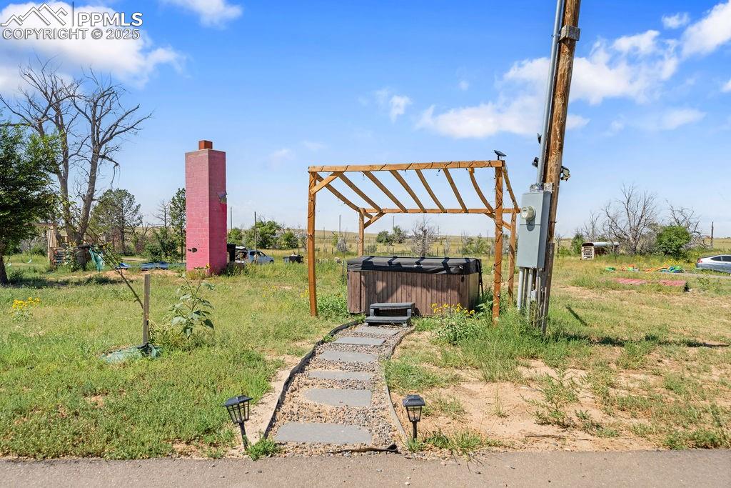 View of yard with a hot tub
