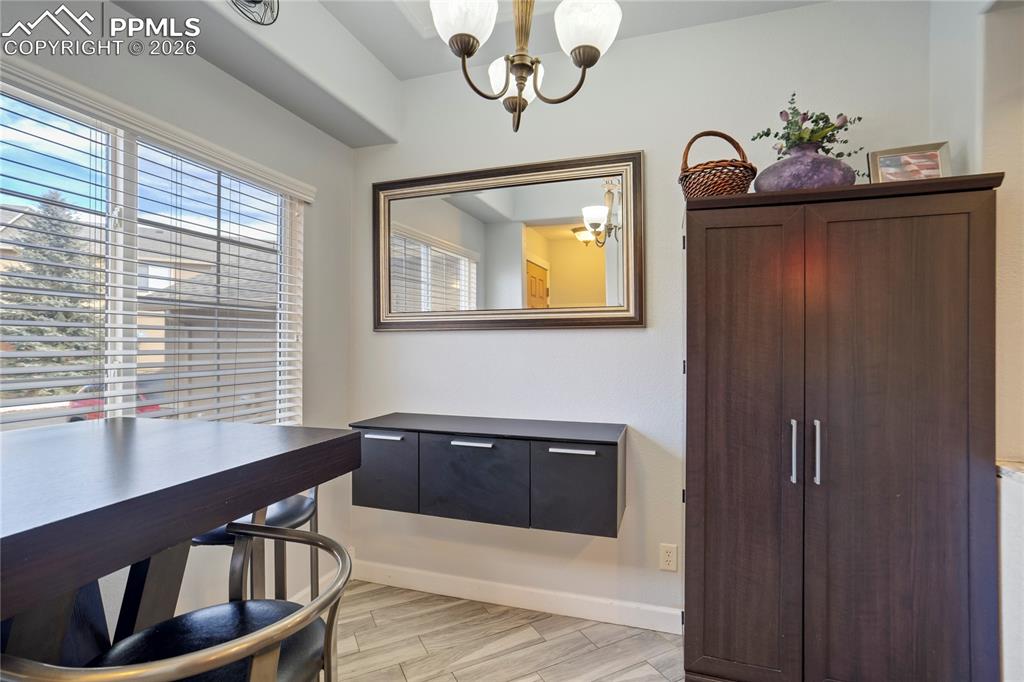 Dining area featuring light wood-style flooring and hanging lights