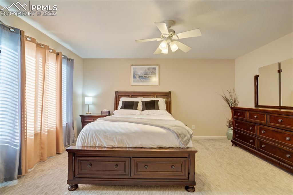 Bedroom featuring light colored carpet and a ceiling fan