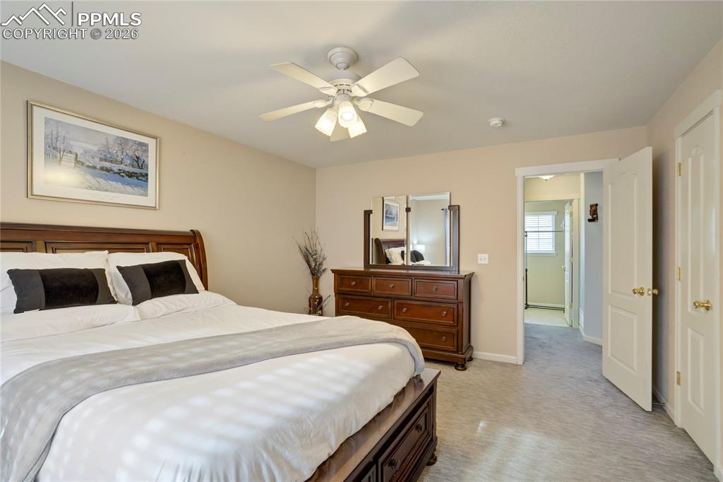 Bedroom with light carpet and ceiling fan