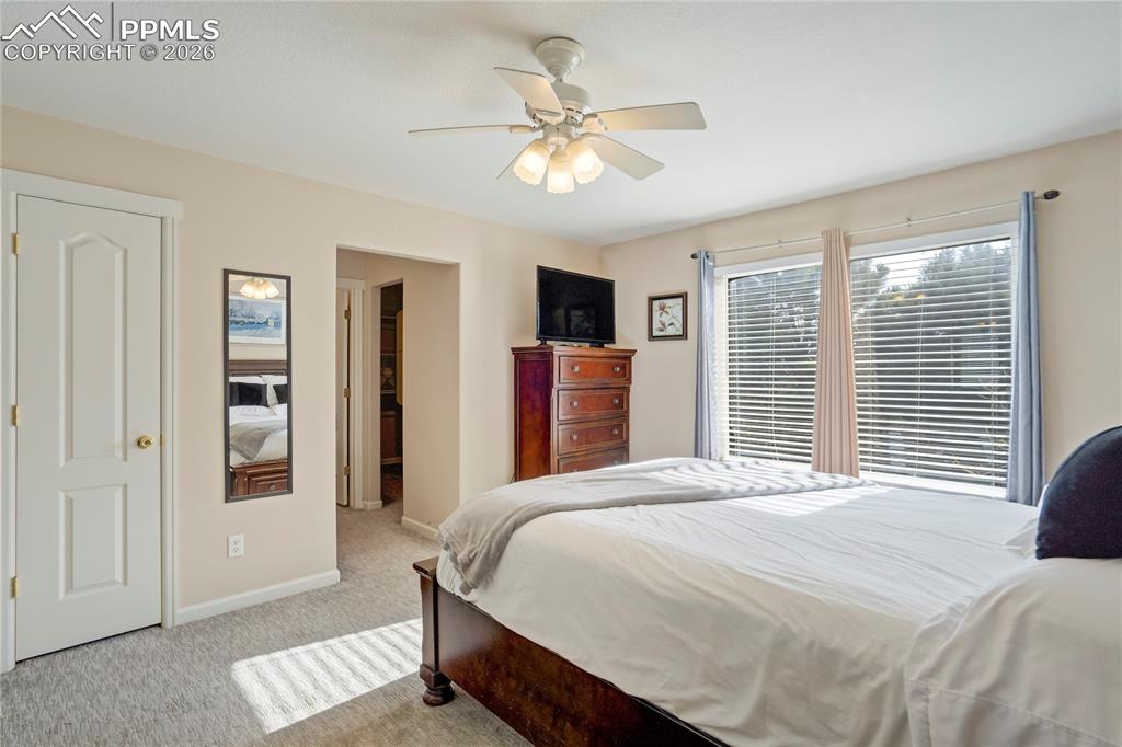 Bedroom featuring light colored carpet and a ceiling fan