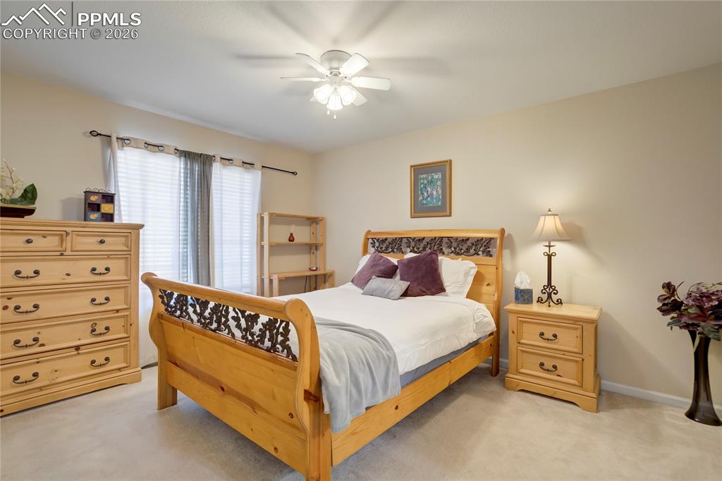 Bedroom featuring light colored carpet and ceiling fan
