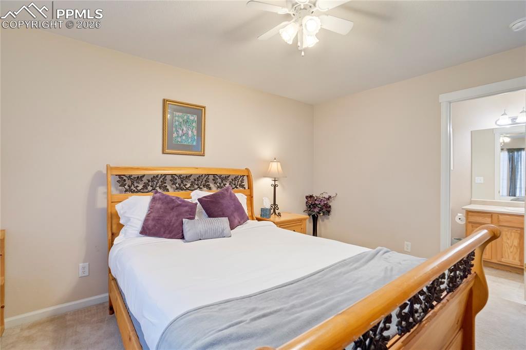 Bedroom featuring light carpet and a ceiling fan