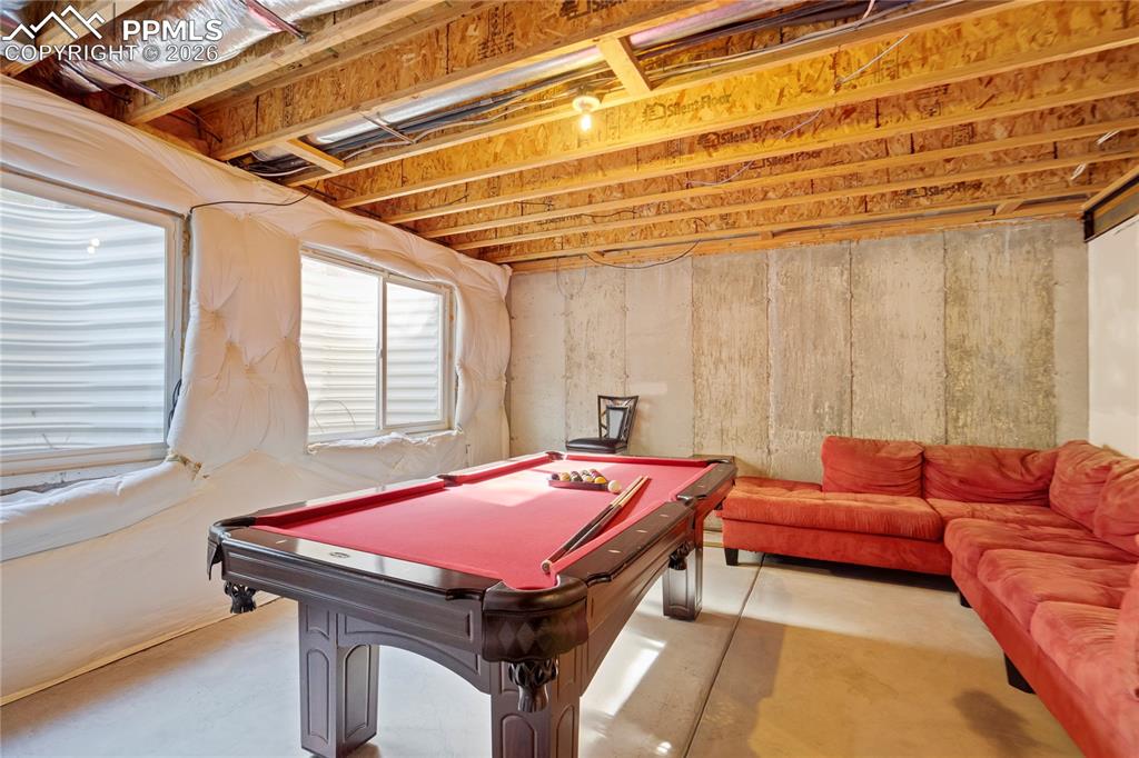Playroom featuring concrete floors and pool table