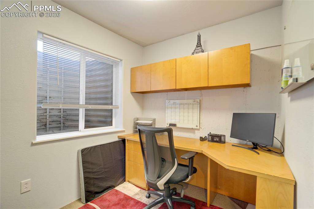 Home office featuring built in study area