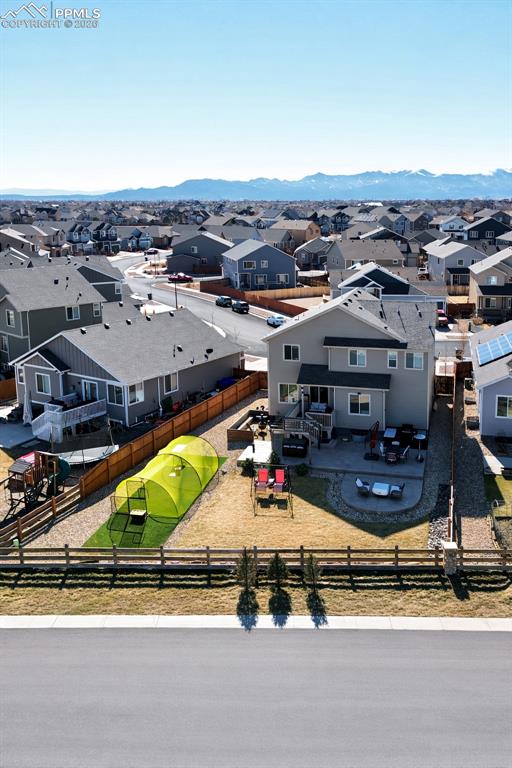 Ariel view showcasing the fenced backyard, patio, and outdoor living spaces perfect for entertaining