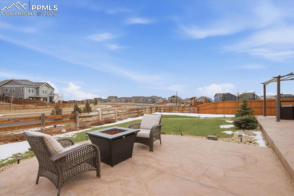 Stamped concrete patio with built in fire pit and gas line, creating a perfect outdoor entertaining space