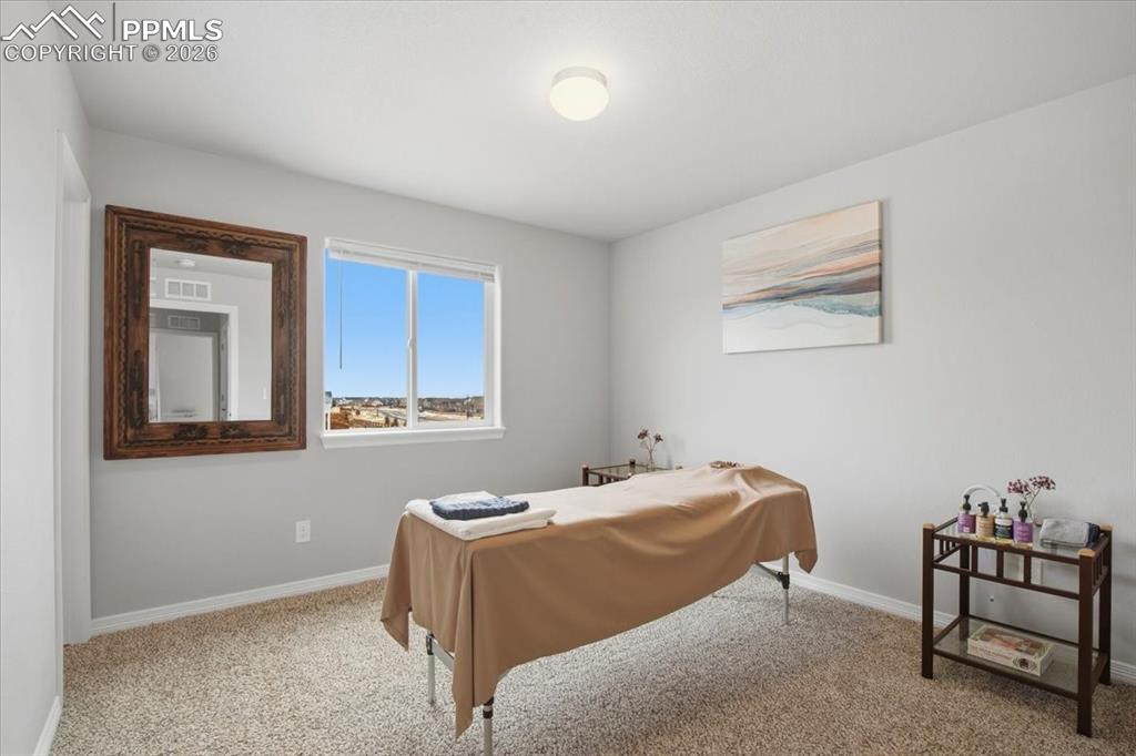 Rear facing second floor bedroom currently used as a massage and wellness room 