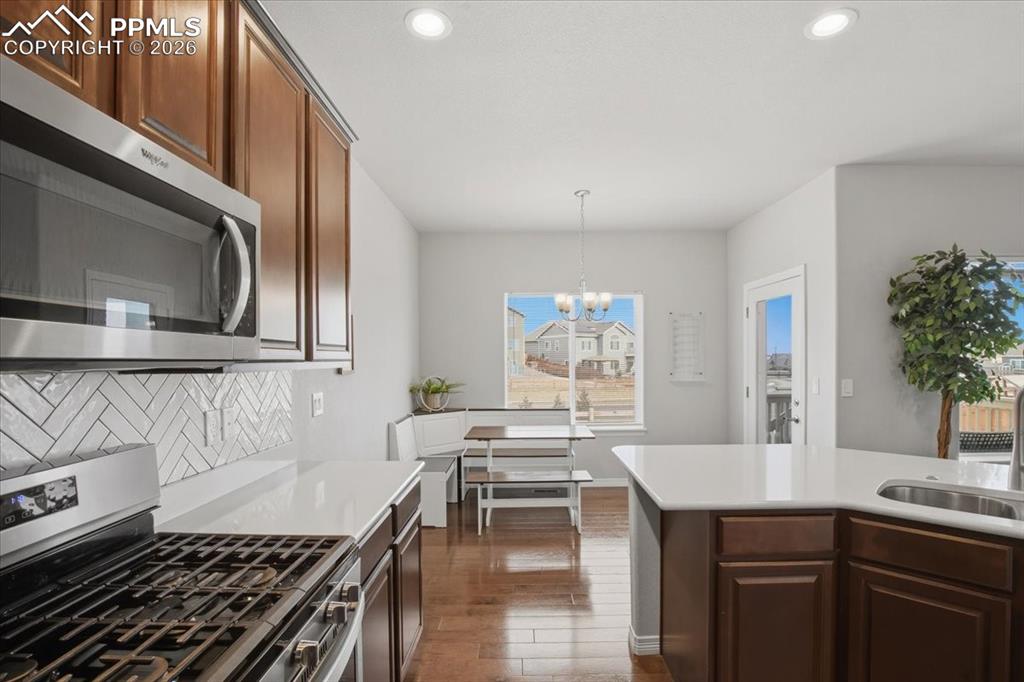 Kitchen featuring decorative backsplash, stainless steel appliances, and modern finish 