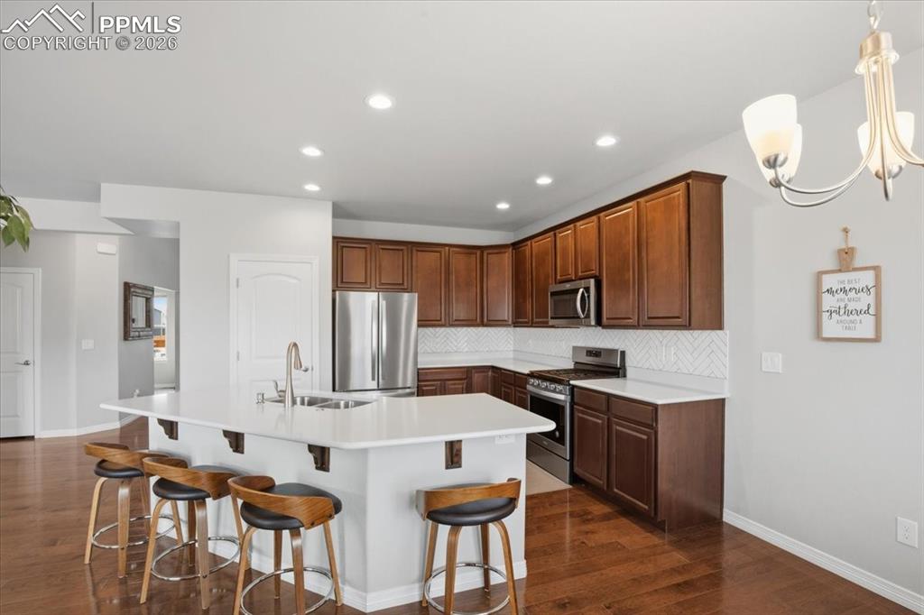Modern kitchen with stainless steel appliances and abundant cabinet storage