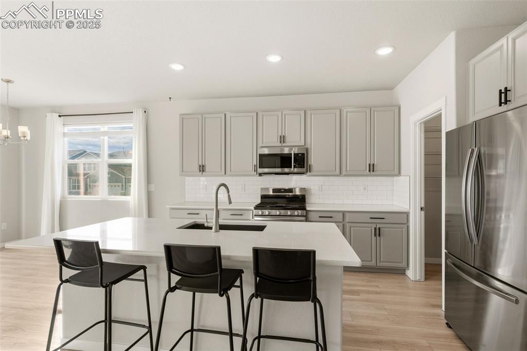 With Beautiful quartz counter tops and big island.   