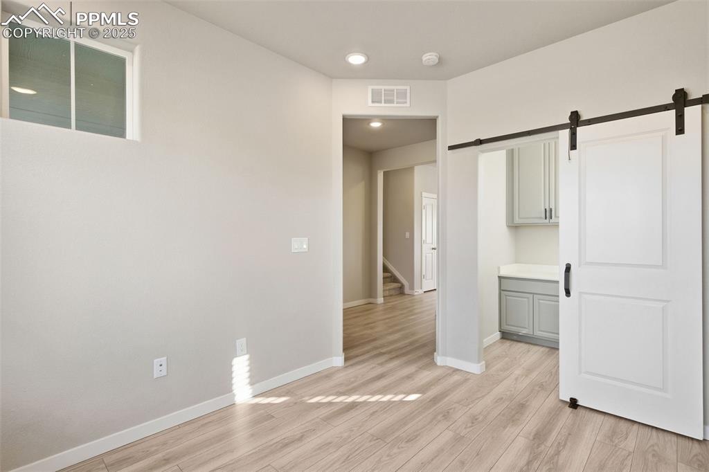 Built in Small Office tucked away behind the barn door in this Bedroom/Office to hide all the mess. Room can be an awesome office or a bedroom. 