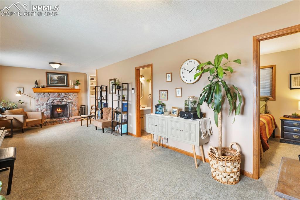 The sitting room has a stone fireplace with a natural wood mantel and rich wood trim!