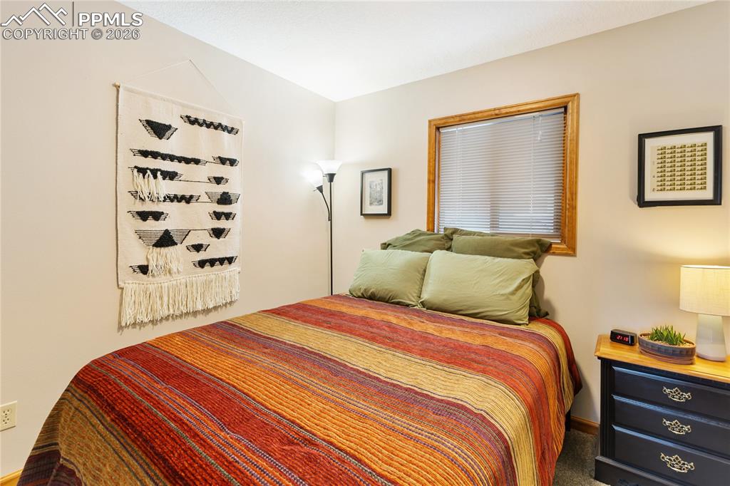 The secondary bedroom features wood trim and a window!