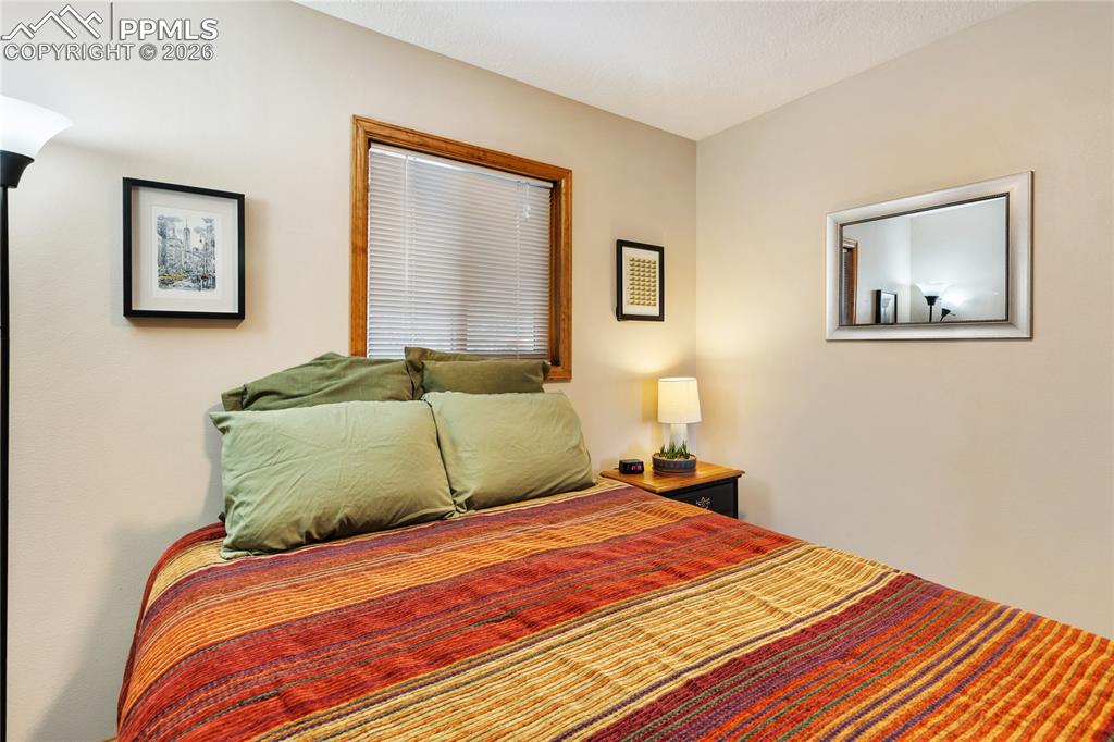 The secondary bedroom features wood trim and a window!