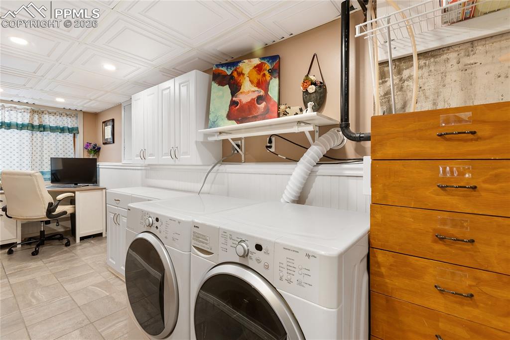 The laundry area overlooks the office, with wainscoting and a coffered ceiling!
