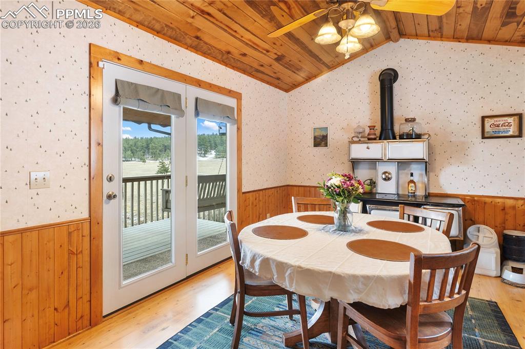 The walkout dining space has a wainscoted wall and a vaulted ceiling, finished with tongue-and-groove wood planks!