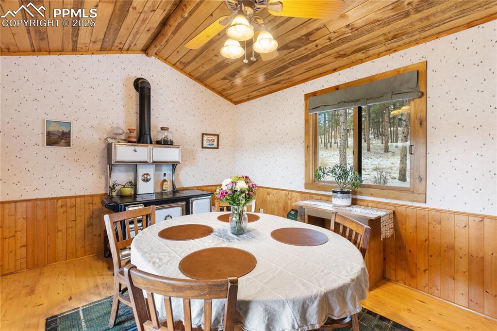 The dining space has a wainscoted wall and a vaulted ceiling, finished with tongue-and-groove wood planks!
