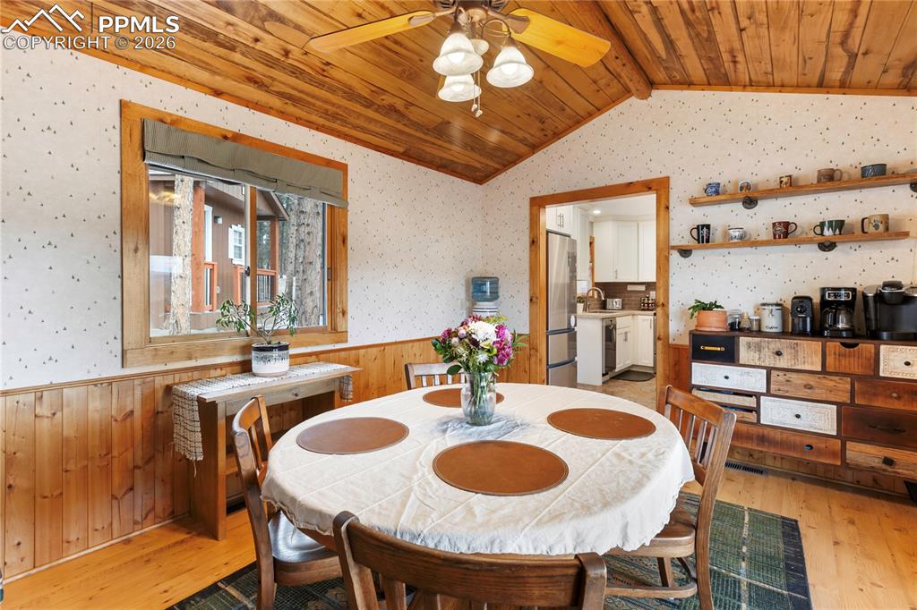 The dining space has a wainscoted wall and a vaulted ceiling, finished with tongue-and-groove wood planks!