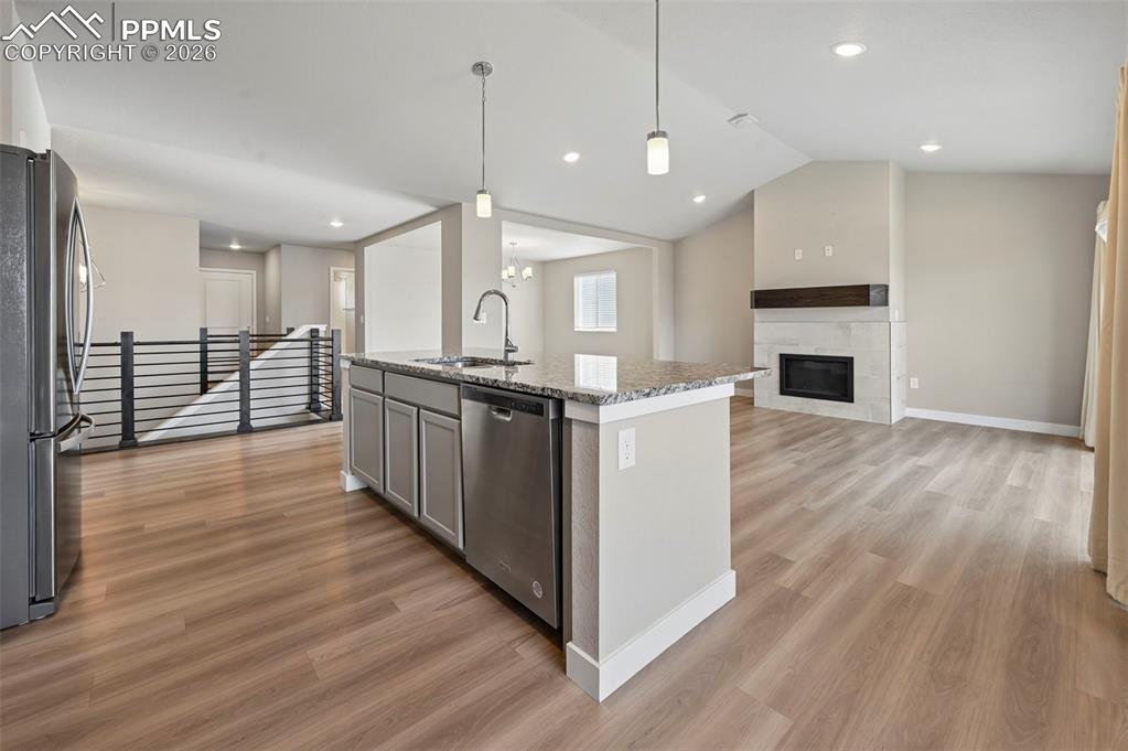 Designer kitchen overlooking living room with fireplace 