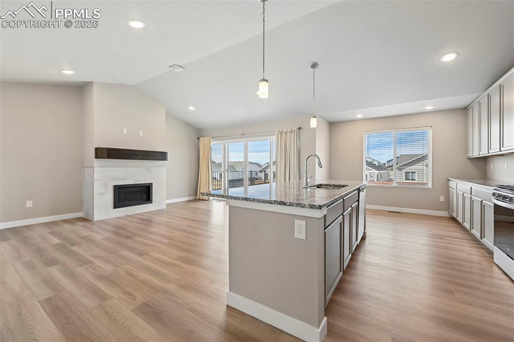 Bright and open concept, kitchen, living room, fireplace and walk-out 