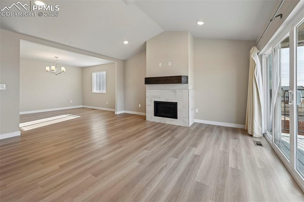 Bright and open concept, dining room, kitchen, living room, fireplace and walk-out