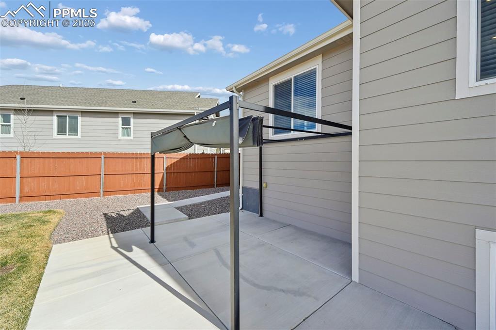 Extended concrete patio with pergola 